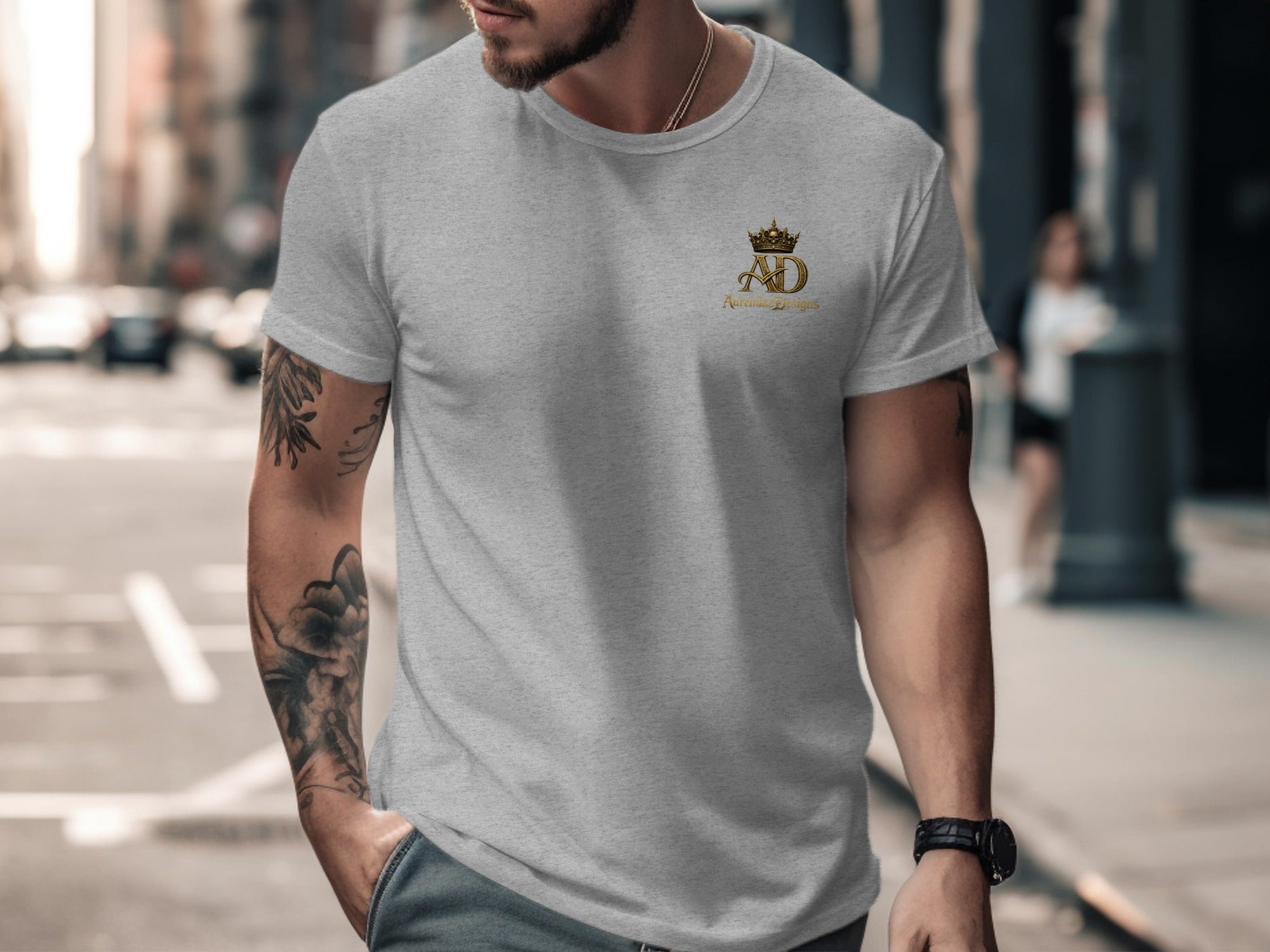 Grey t-shirt with gold AD crown logo and "Adrian Design" text.