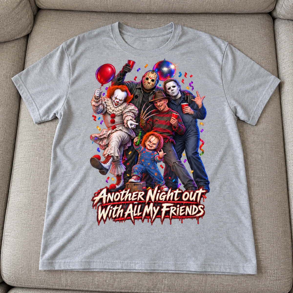 Heather Gray Halloween T-shirt mockup with five horror characters partying above Another Night Out With All My Friends, laid flat on a neutral couch.
